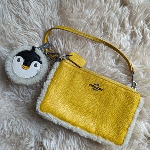 Coach wristlet wallet with penguin charm